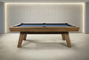 Side view of the George pool table in Glazed Maple without the dining top, highlighting the sculptural leg angles, solid maple frame, and clean mid-century proportions.