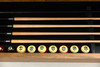 Close-up view of the Doc & Holliday storage bench opened to reveal integrated cue stick storage, highlighting the clean interior layout, premium materials, and furniture-grade craftsmanship.