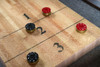Tight shot of the maple shuffleboard playfield with its smooth epoxy surface, highlighting the natural grain and craftsmanship of the George Shuffleboard in Antique Coffee.