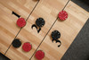 Close-up of Doc & Holliday Savant shuffleboard table maple playfield showing polymer-coated surface and recessed scoring markers.