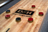 Doc & Holliday Savant shuffleboard table maple playfield with recessed scoring numbers and polymer performance surface in a close-up gameplay view.