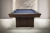 End view of The Rook slate pool table showing the pedestal base, tapered rails, leather pockets, and Championship blue felt.