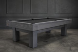¾ hero view of the Doc & Holliday Dallas Slate Pool Table in Smoke Maple distressed grey finish, photographed during a styled lifestyle shoot with a Restoration Hardware–inspired backdrop. Highlights the squared Parsons legs, finger-jointed rails and apron detailing, rustic pine texture, and Doc & Holliday luxury billiard balls displayed across the slate playfield.