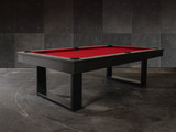 3/4 lifestyle view of the Doc & Holliday Billiards Santorini Slate Pool Table in black finish with red Championship felt styled in a modern high-end residential interior 3/4 lifestyle view of the Doc & Holliday Billiards Santorini Slate Pool Table in black finish with red Championship felt styled in a modern high-end residential interior