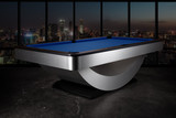 Three-quarter view of the Doc & Holliday Poshy Reverse Rainbow Slate Pool Table with Euro Blue Championship felt, matte black upper rails, and brushed metallic base, staged on a concrete floor with a modern backdrop wall. Three-quarter view of the Doc & Holliday Poshy Reverse Rainbow Slate Pool Table with Euro Blue Championship felt, matte black upper rails, and brushed metallic base, staged on a concrete floor with a modern backdrop wall.