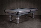 3/4 angled view of the Doc & Holliday Classic slate pool table in a gray washed pine finish, handcrafted in the USA with solid northern pine construction. The image highlights the traditional fluted legs, genuine leather drop pockets, and the smooth slate playfield set against a styled backdrop. 3/4 angled view of the Doc & Holliday Classic slate pool table in a gray washed pine finish, handcrafted in the USA with solid northern pine construction. The image highlights the traditional fluted legs, genuine leather drop pockets, and the smooth slate playfield set against a styled backdrop.