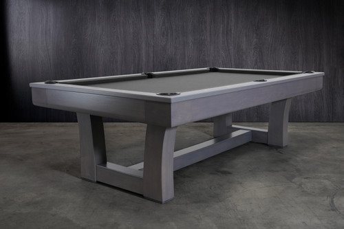 ¾ hero view of the Doc & Holliday Everly Slate Pool Table in Smoke Maple finish, professionally shot with a styled backdrop. Showcases the sculptural wave-inspired legs, curved apron design, and genuine three-piece slate playfield with a clean, design-forward presence.