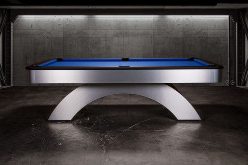 Side profile view of the Doc & Holliday Poshy Rainbow Slate Pool Table, showcasing its brushed metallic base with rainbow gradient, matte black upper rails, and Euro Blue Championship felt, staged on a concrete floor with a clean modern backdrop wall.