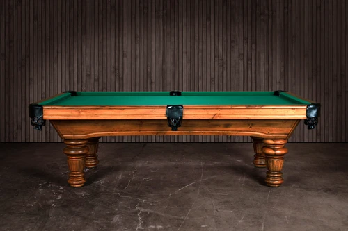 Side profile view of The Classic showing the solid pine frame, traditional apron detailing, and turned legs. The green felt surface provides a striking contrast, emphasizing both rustic warmth and tournament-level craftsmanship.