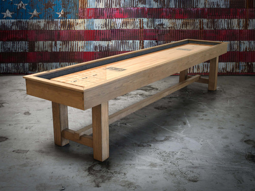 The Hank Shuffleboard Table by Doc & Holliday, shown in a three-quarter view with our Oaklee finish. Staged against a bold American flag backdrop, this rustic masterpiece captures the essence of timeless design and the craftsmanship of heirloom-quality game room furniture.