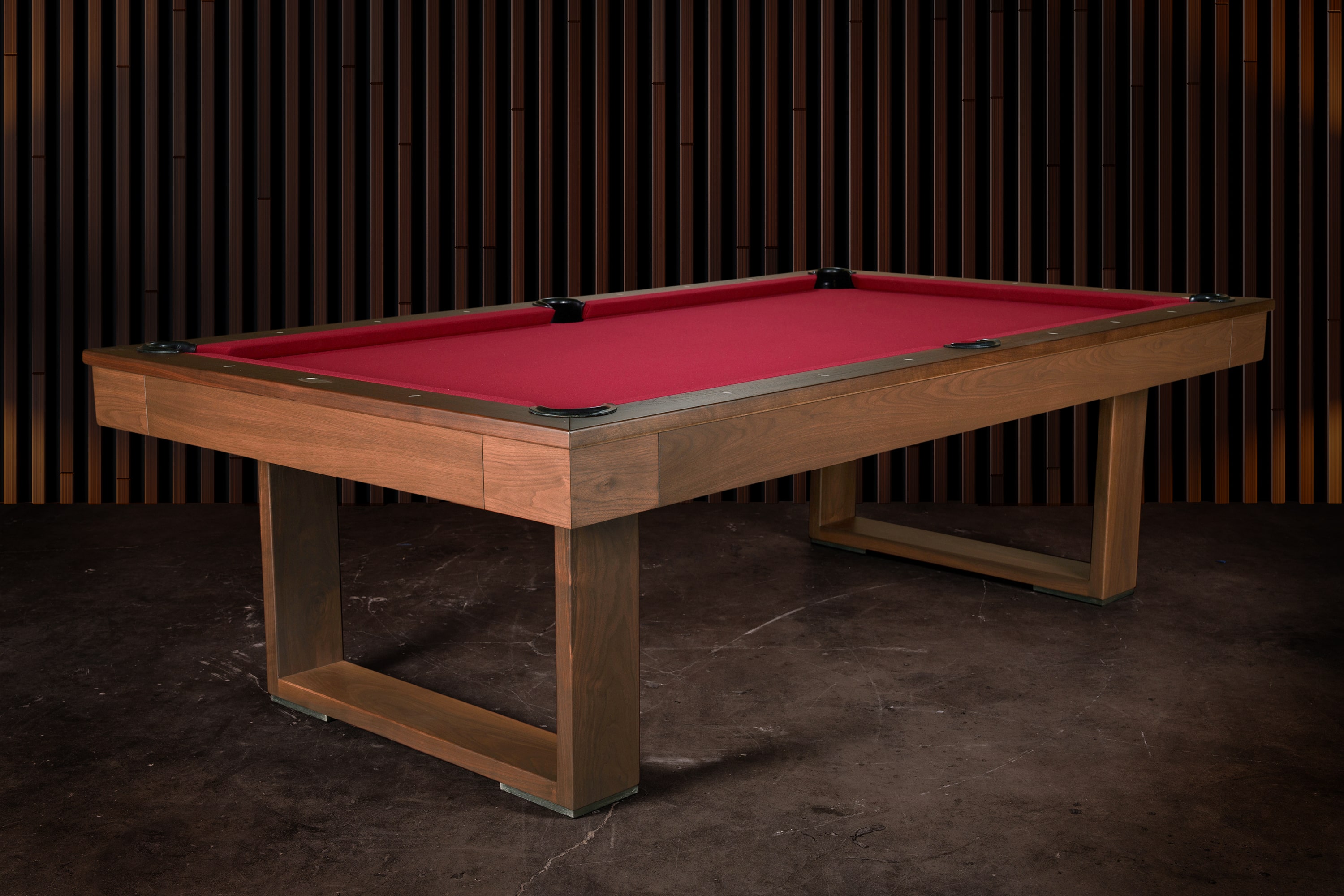 3/4 lifestyle view of the Doc & Holliday Billiards Santorini Slate Pool Table in walnut staged against reeded wood walls with cinematic lighting in a high-end interior