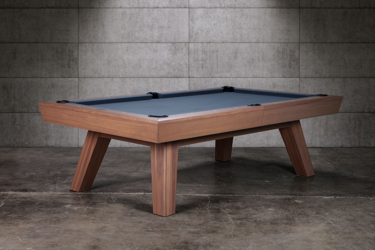 The Doc & Holliday George Slate Pool Table in Gray Walnut captured in a bold 3/4 angle, showcasing its mid-century modern flared legs and solid acacia wood construction. The sleek cabinet and exclusive finish give this slate billiard table a cinematic presence that commands attention in any luxury game room or commercial setting.