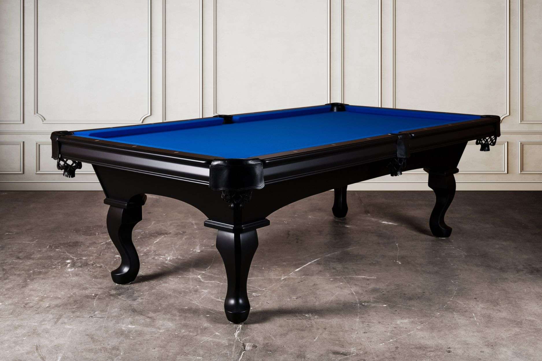 The Doc & Holliday Elvira Slate Pool Table shown in a 3/4 studio view with a rich black hardwood finish and royal blue Championship felt. Its Queen Anne-style legs, leather drop pockets, and maple rails with mother-of-pearl sights create a blend of traditional craftsmanship and modern precision. A made-in-USA slate billiard table designed for both style and play.
