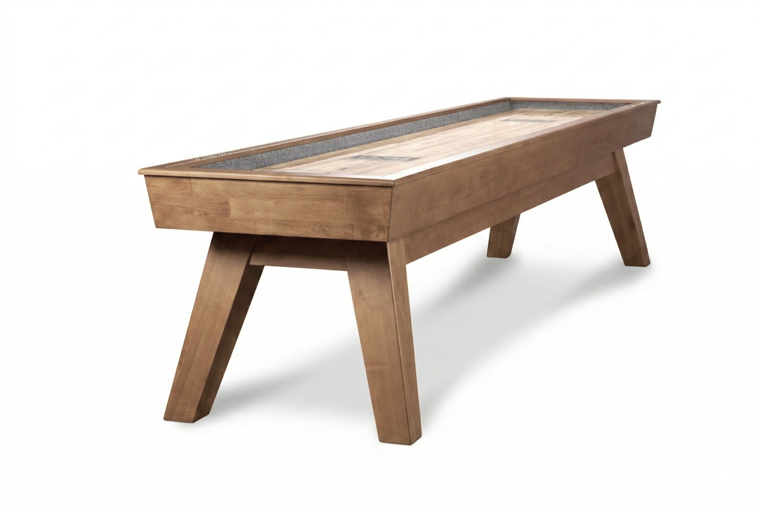 Three-quarter view of the Doc & Holliday George shuffleboard table in Glazed Maple, showcasing warm maple grain, sculpted flared legs, recessed scoring, and a 12-foot professional playfield with architectural presence.