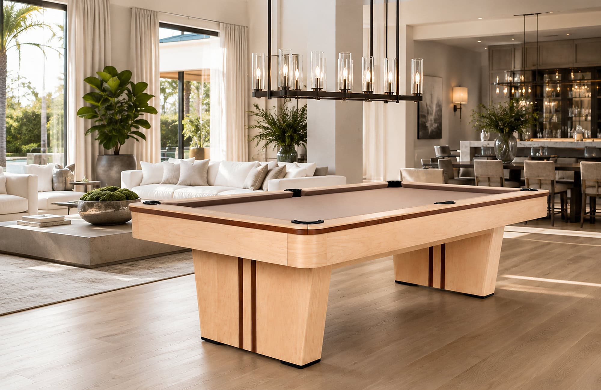 Doc & Holliday Derby Slate Pool Table in natural maple with walnut inlays, styled in a luxury open-concept game room.