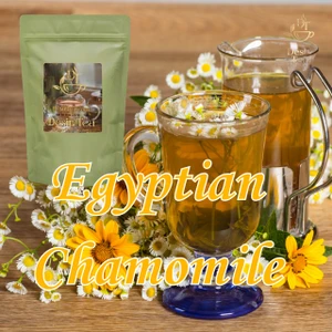 Desir Tea Egyptian Chamomile herbal tea next to a glass mug of chamomile tea and white flowers.