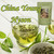Fresh green tea leaves float inside a clear glass cup of herbal infusion alongside a pouch of Desir Tea.