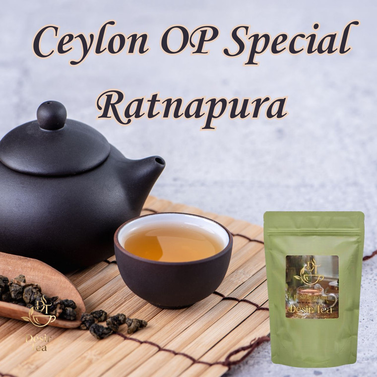 A dark clay teapot sits next to a matching teacup of golden tea and a wooden scoop of rolled tea leaves on a bamboo mat.
