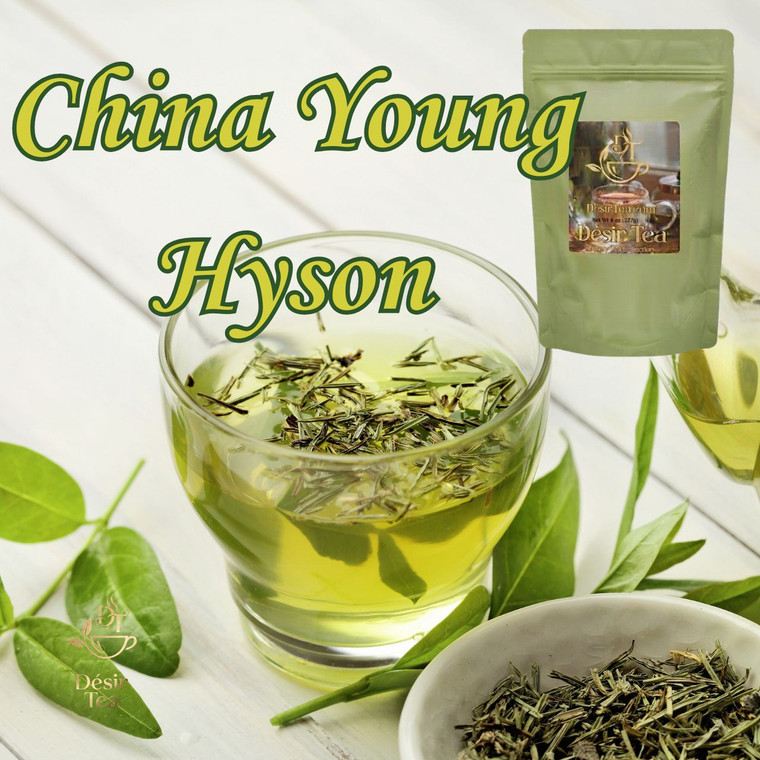 Fresh green tea leaves float inside a clear glass cup of herbal infusion alongside a pouch of Desir Tea.