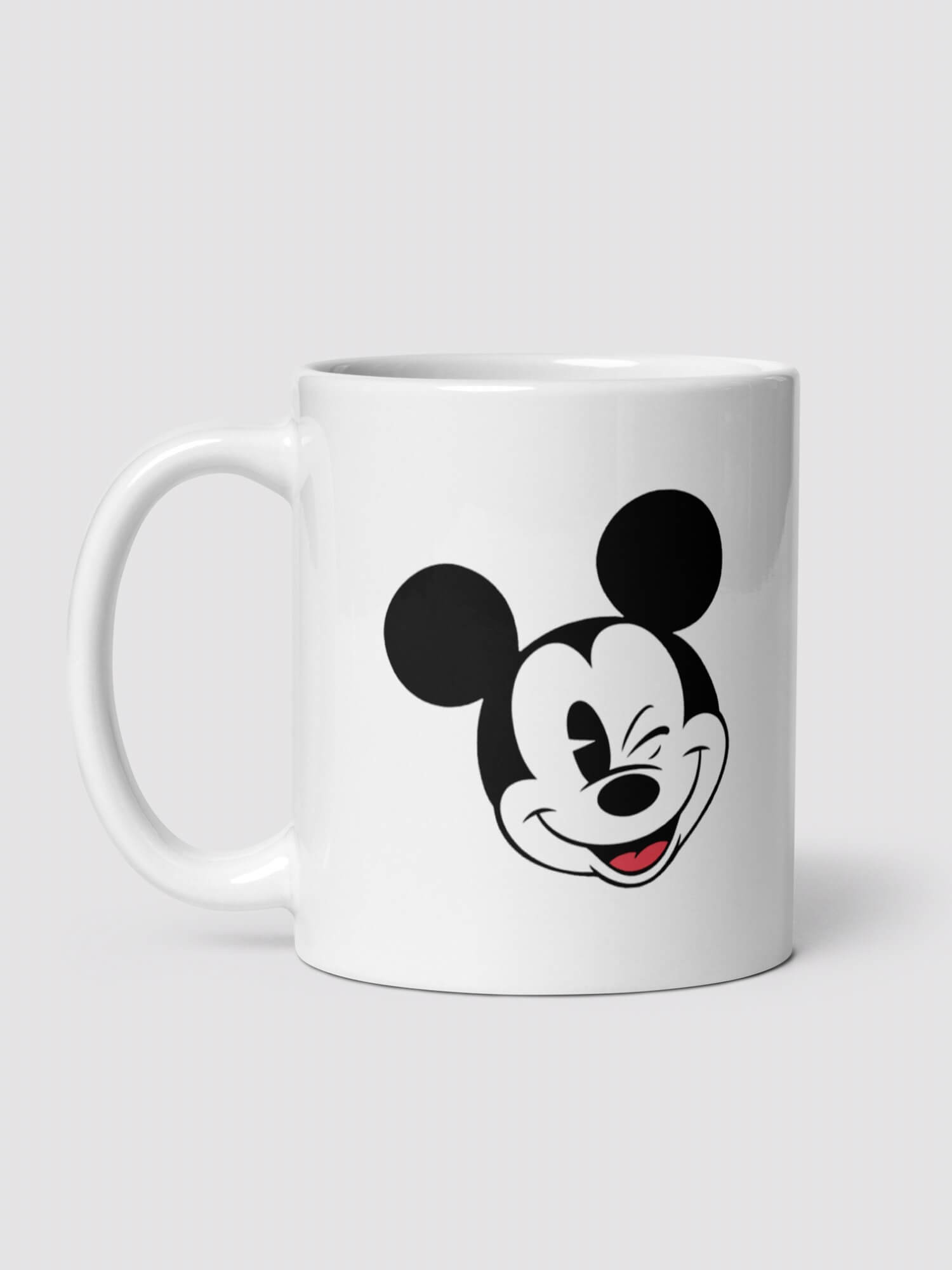Mickey Mug      Mickey Mouse winking face profile ceramic drinks cup coffee, tea, juice, milk drinking cups in white with black design collections Disney souvenirs collectors ceramics mugs