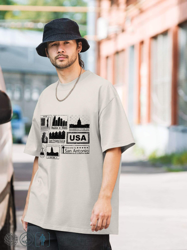 Oversized Faded Graphic T-Shirt Genderful Unisex Anywear Men’s Women’s Cartoon city stamp print short sleeves crewneck round o-neck crew neck tees T-Shirts for man woman in khaki beige with black pattern Mens Womens USA American cities New York, Houston, Texas, Los Angeles, California, Washington DC, Philadelphia, Austin, San Antonio, Texas, United States Of America Gifts petite tall plus size Tops