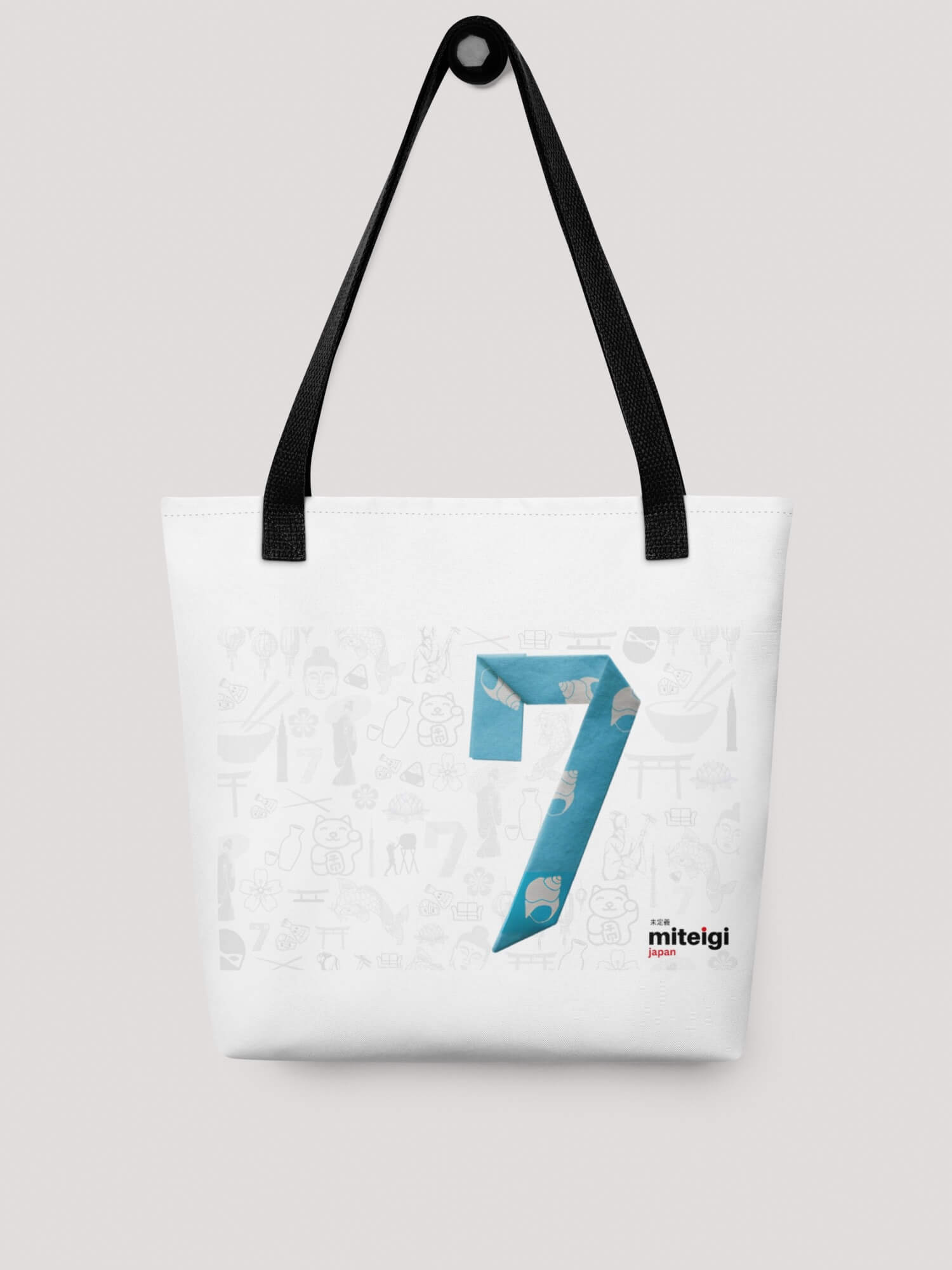 7th Anniversary Tote Bag in white with black handles and gray small traditional Japanese icons, landmarks and features with a large light sky blue origami number 7 and miteigi Japan company logo in bottom right of centered rectangular anniversary motif.
