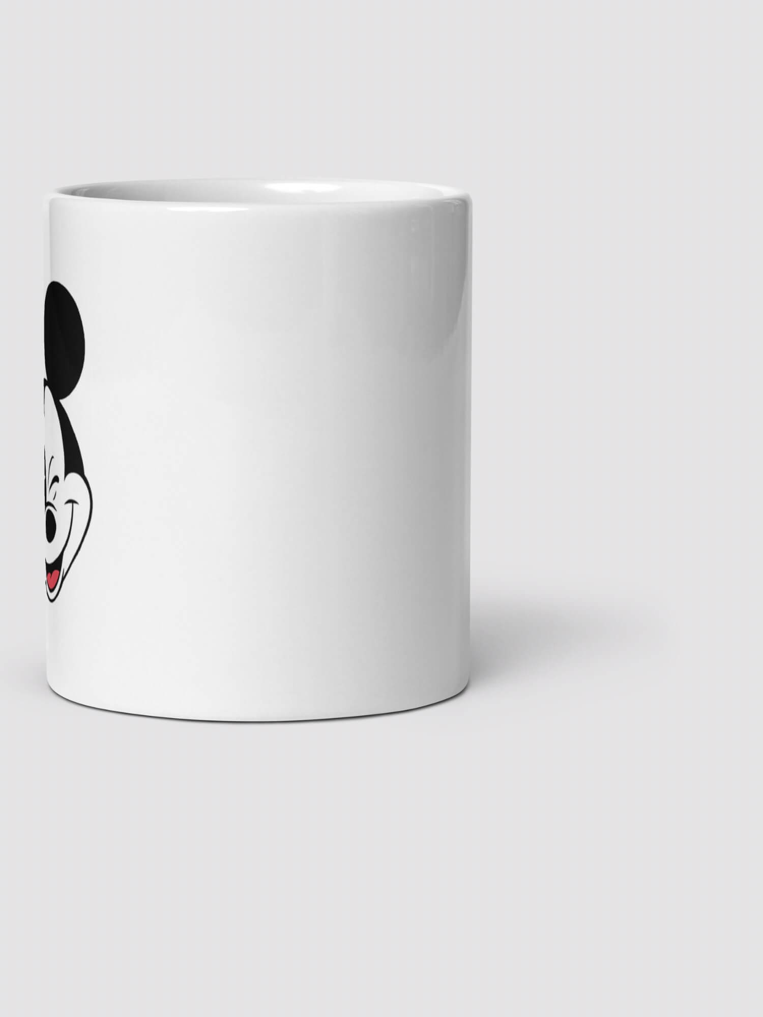 Mickey Mug      Mickey Mouse winking face profile ceramic drinks cup coffee, tea, juice, milk drinking cups in white with black design collections Disney souvenirs collectors ceramics mugs