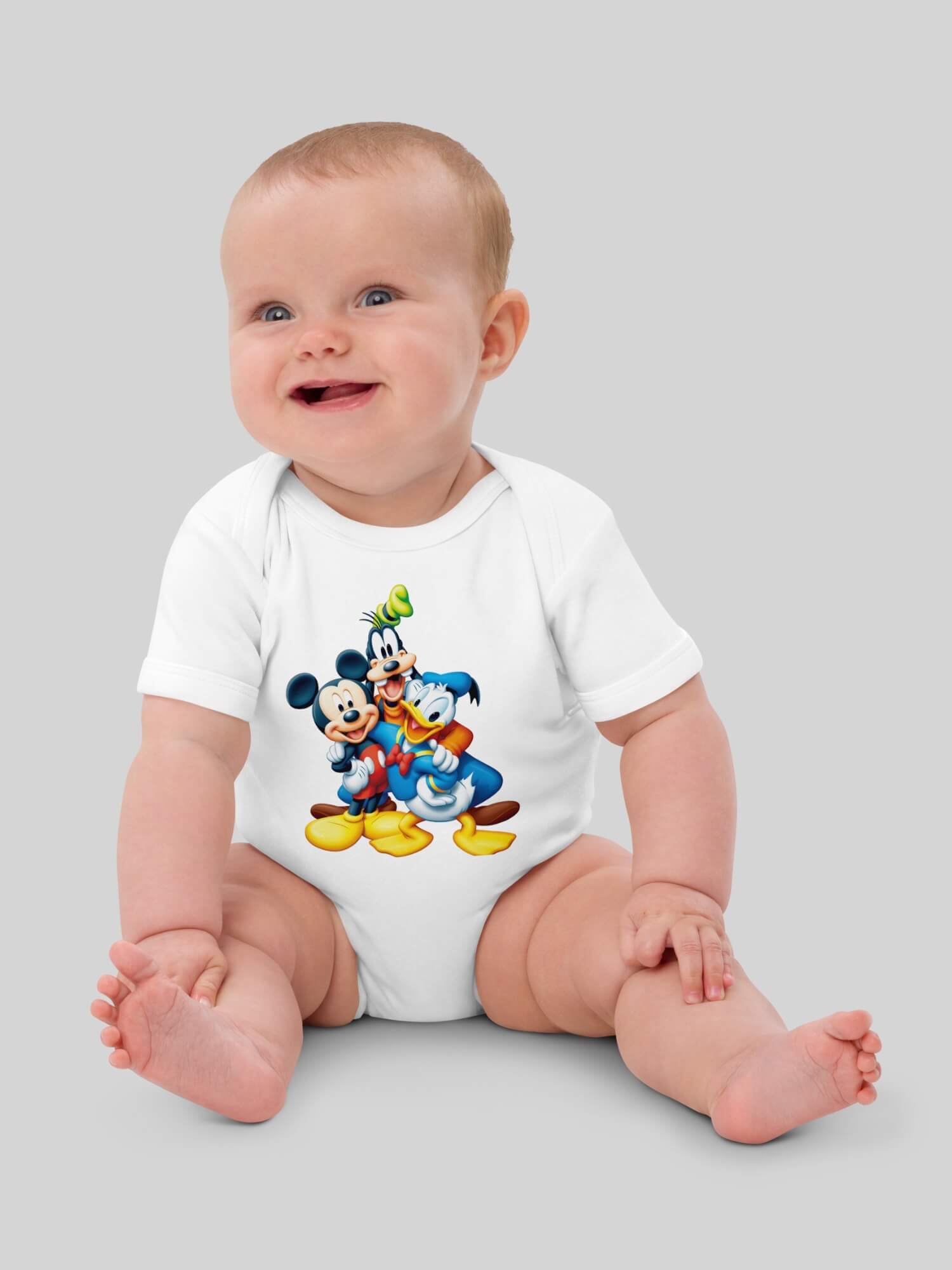 Baby Organic Cotton Disney Bodysuit   Genderful vegan Unisex boys girls  100% Cotton Linen  Goofy Mickey Mouse Donald Duck cartoon animal short sleeves crewneck envelope neckline round o-neck three (3) button inseam snaps bottom closure one piece outfit in white with multi Babies crew neck bodysuits outfits