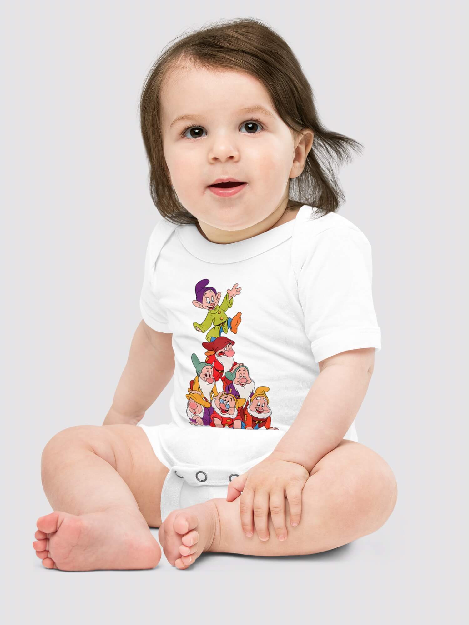 Baby Print One Piece    Bella + Canvas Genderful vegan Unisex boys girls  100% Cotton Linen  Disney The Seven Dwarfs from Snow White cartoon animal short sleeves crewneck envelope neckline round o-neck three (3) button inseam snaps bottom closure one piece outfit in white with multi color Babies crew neck bodysuits outfits