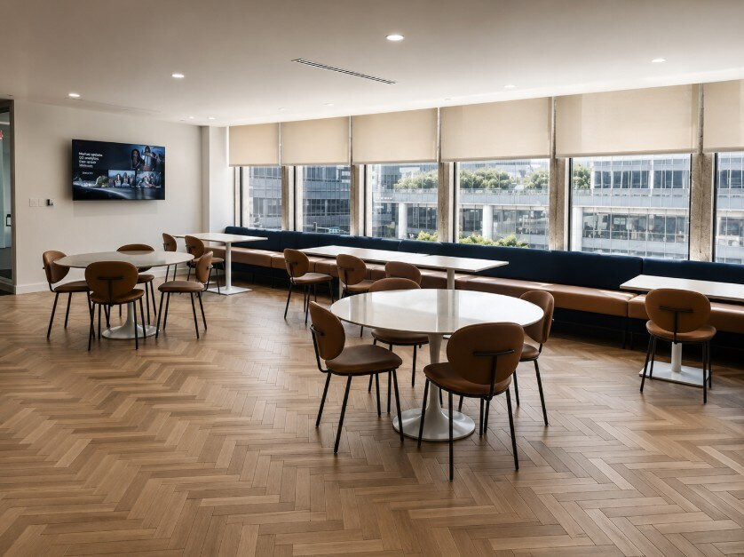 Agellus Capital headquarters breakroom with cafe tables and window seating