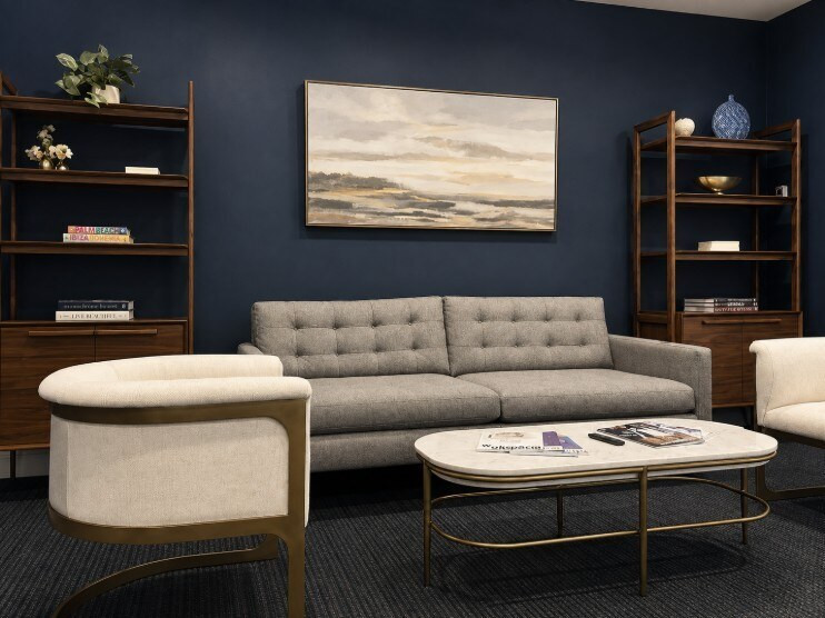 Agellus Capital headquarters lounge with upholstered seating and display shelving
