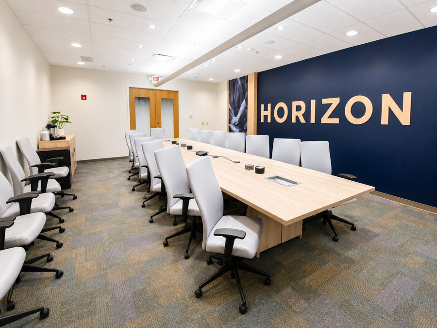 Biotechnology headquarters conference room with large meeting table and commercial seating