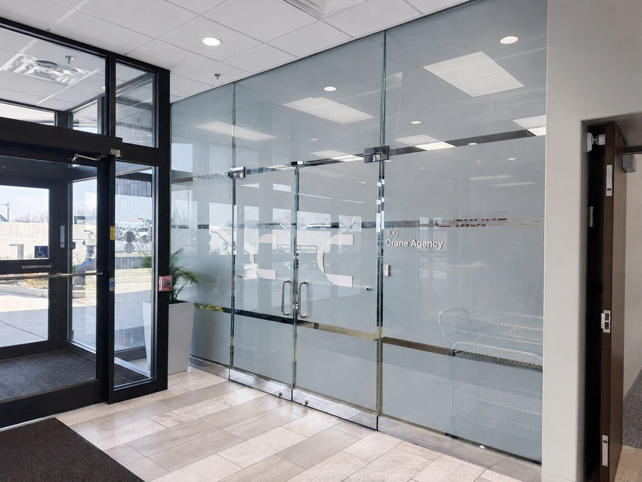 Branded glass entrance at the Crane Agency headquarters