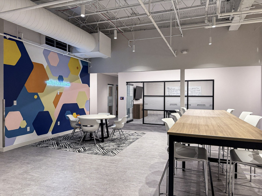 Gateway Fiber headquarters collaboration space with branded mural and flexible tables