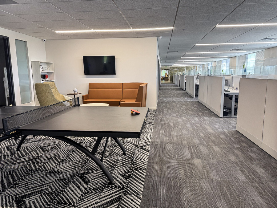 Gateway Fiber open office with premium pre-owned workstations and adjacent lounge seating