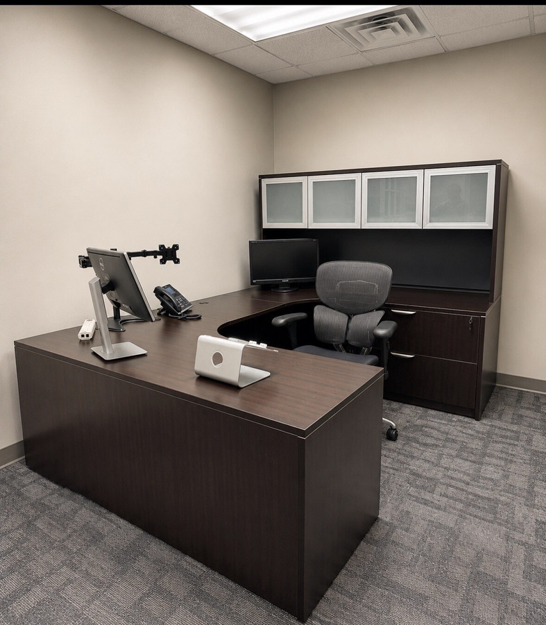 StrategiCom private office with relocated executive desk and storage
