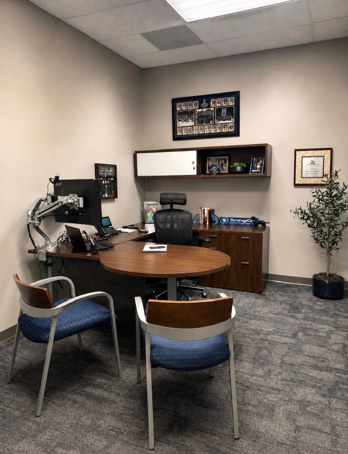 StrategiCom private office furnished with an existing executive desk