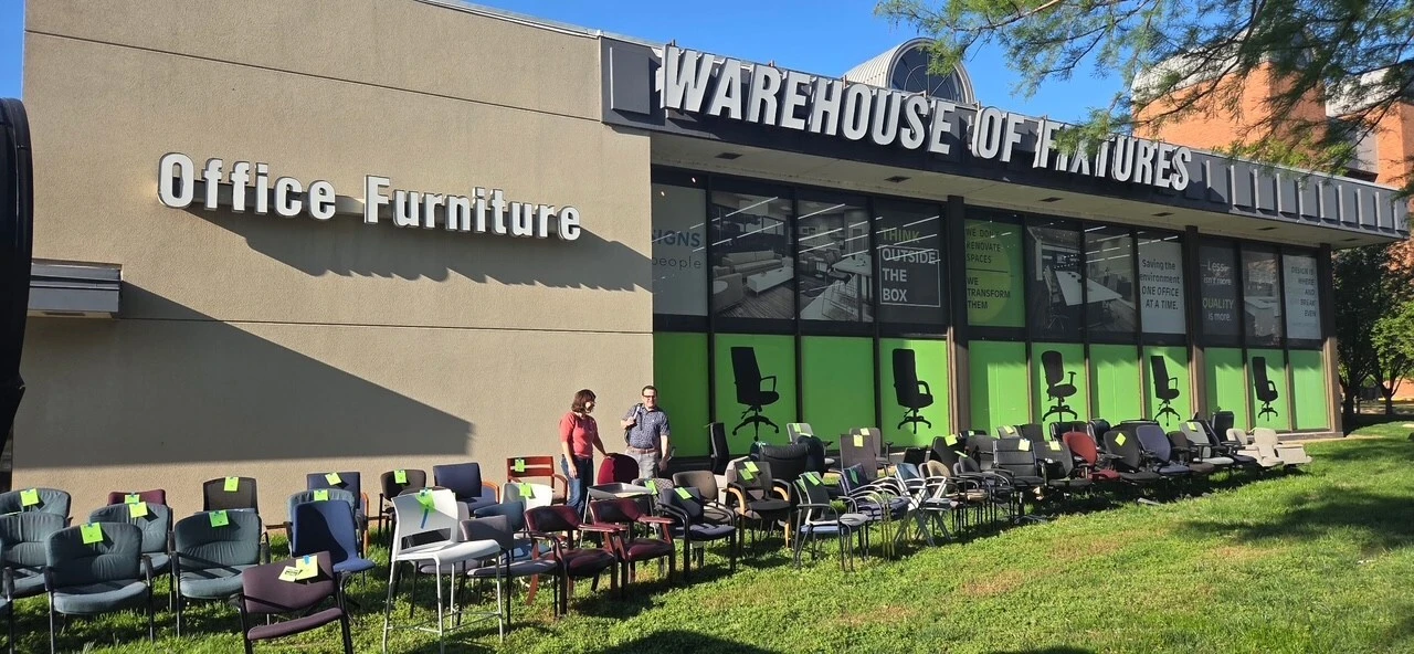 Community members picking up office chairs