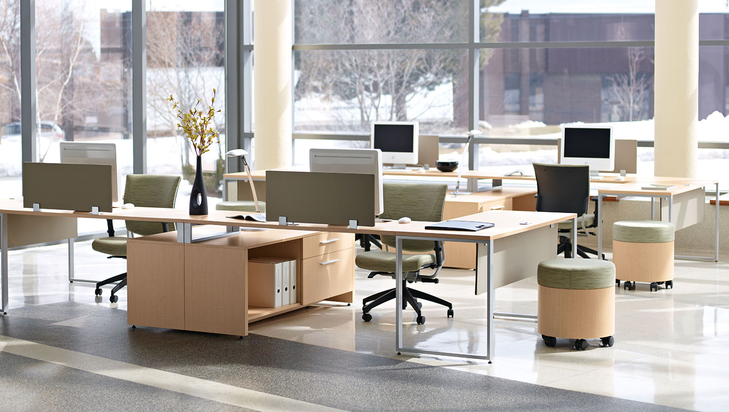 Modern open plan office furniture workstations by Warehouse of Fixtures with computers and green chairs.