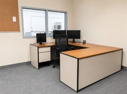Temporary office workspace furnished for Hughes Customat after a facility fire