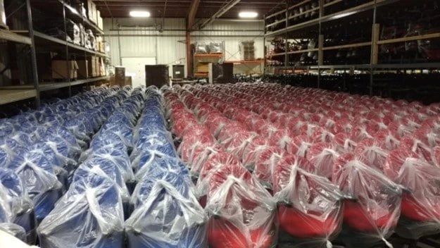Rows of commercial office chairs stored for reuse in the WOF warehouse