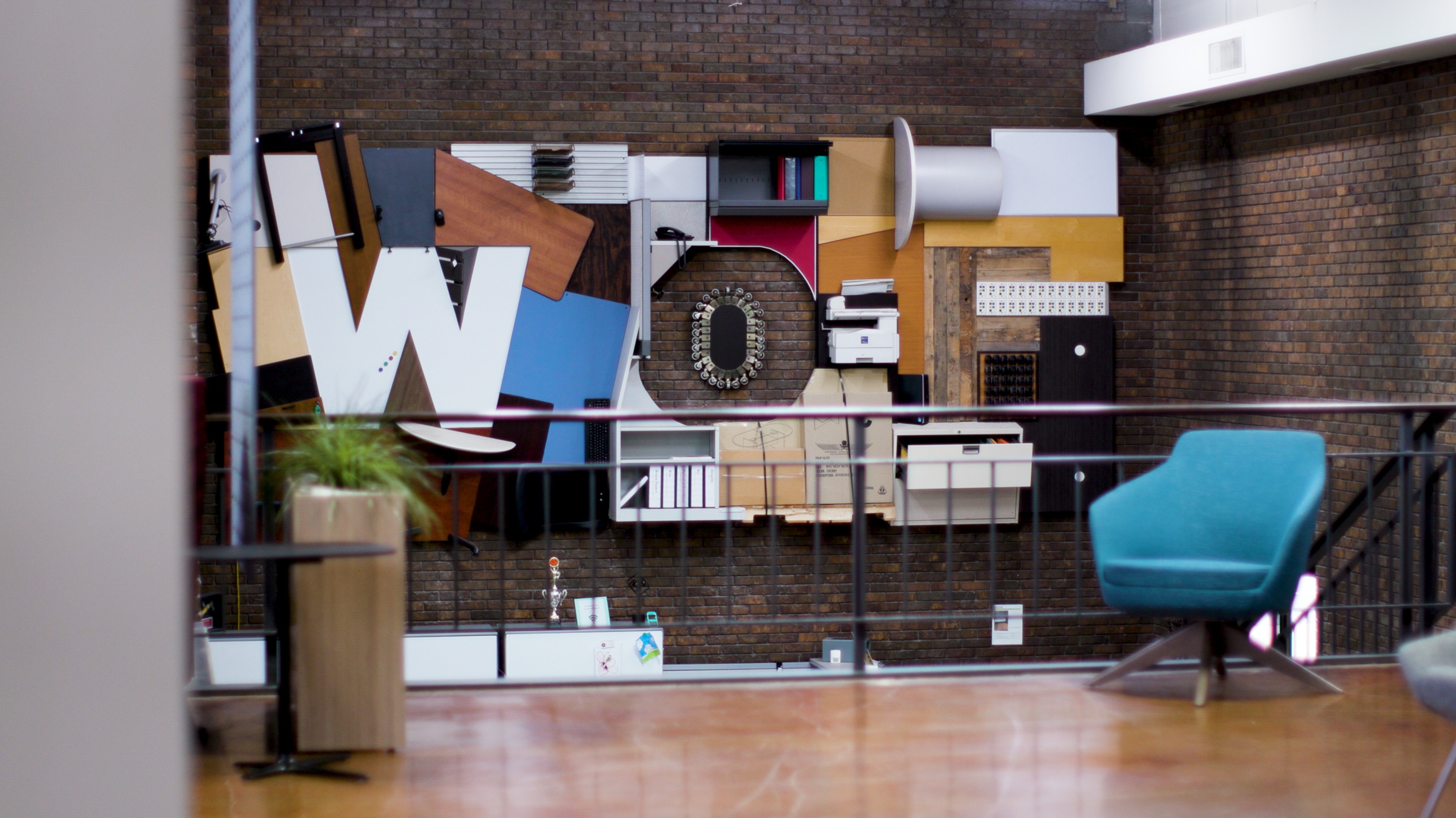 Custom WOF lobby artwork made from reclaimed office furniture and equipment at Warehouse of Fixtures TNG in St. Louis