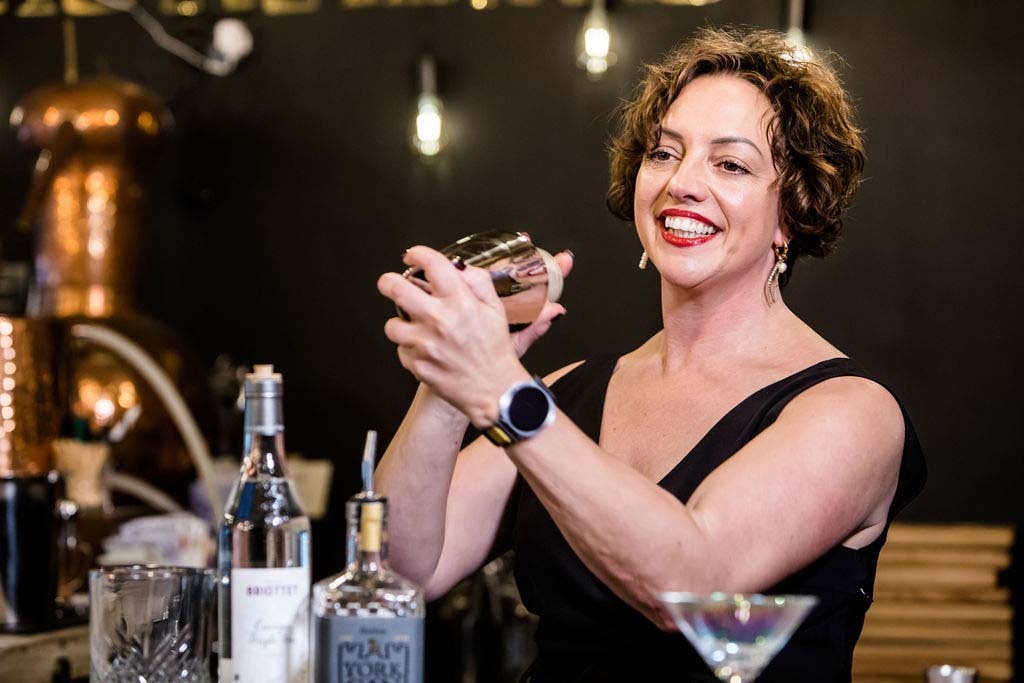 Host demonstrating cocktail making at York Distillery