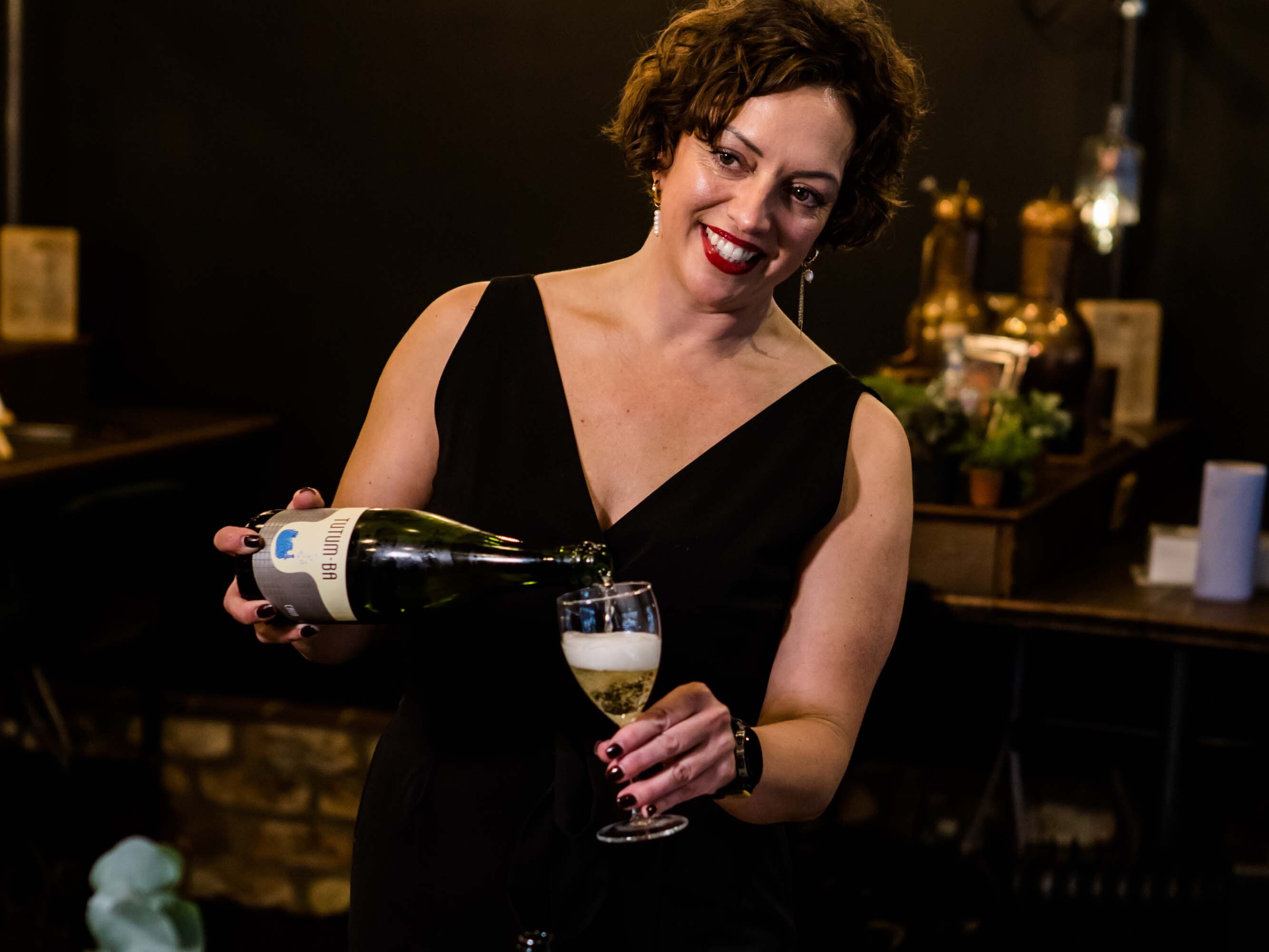 Emma Moore pouring wine at the Wine Tasting Club at York Distillery