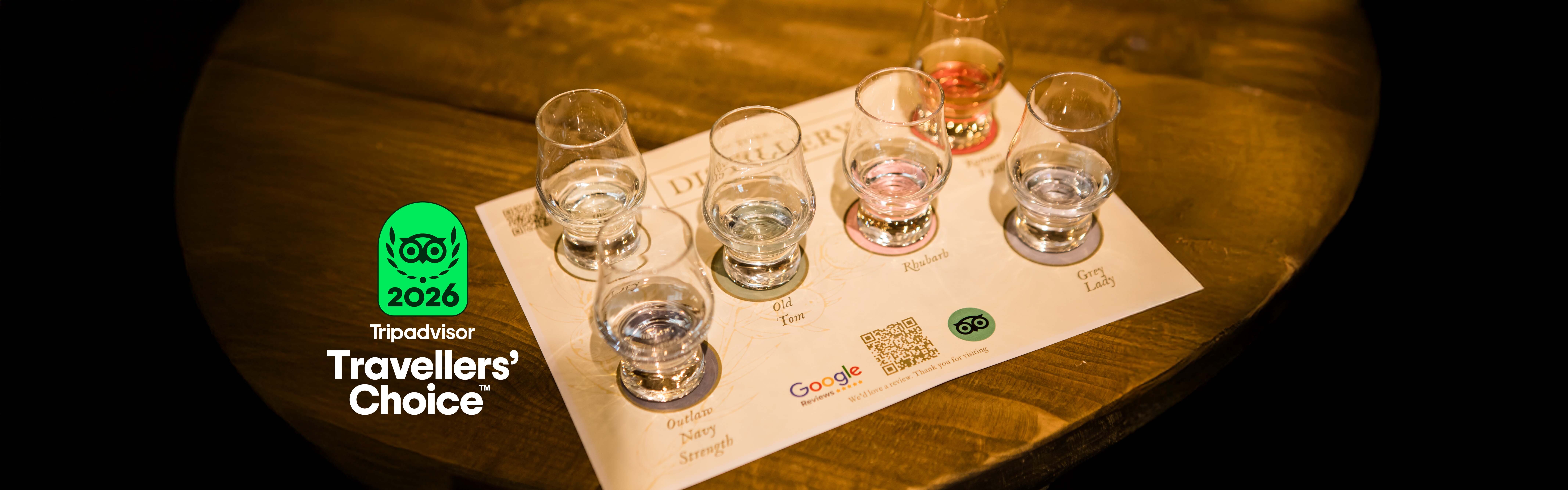 Gin tasting glasses with York Gin on a tasting mat at York Distillery with Tripadvisor travellers' choice award badge 2026
