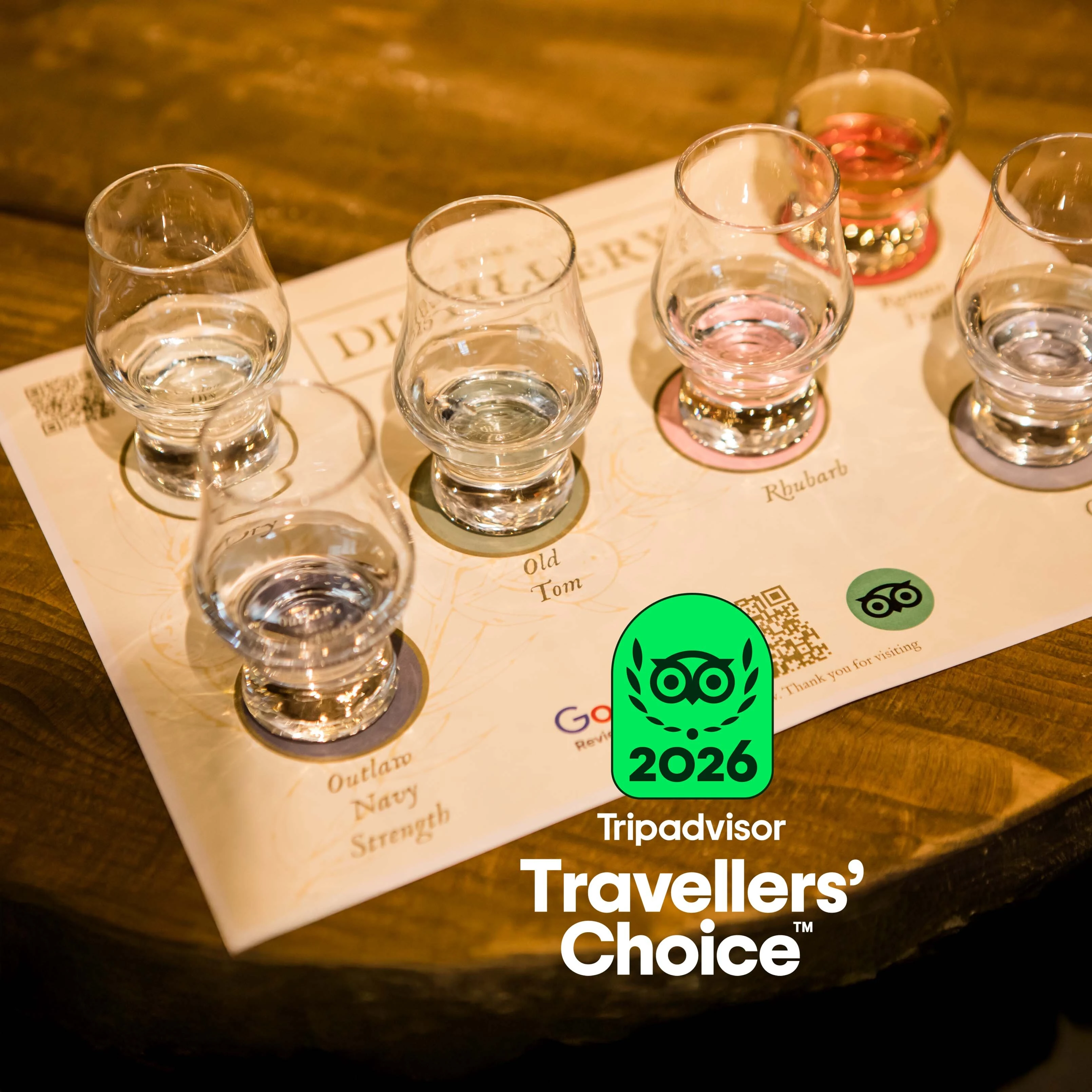 Gin tasting glasses with York Gin on a tasting mat at York Distillery with Tripadvisor travellers' choice award badge 2026