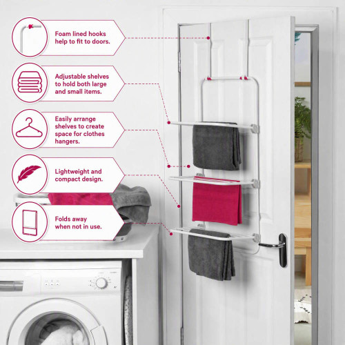 White over-door towel rack with three rails holding grey and pink towels