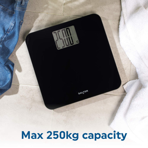 Black digital bathroom scale with 250kg max capacity, display shows weight in kg.