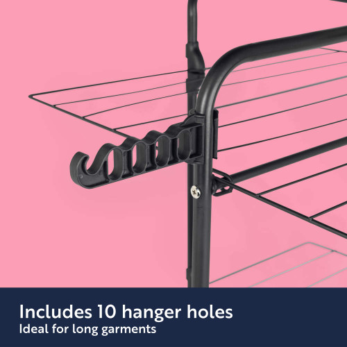Black drying rack side view showing 10 hanger holes for long garments against pink background