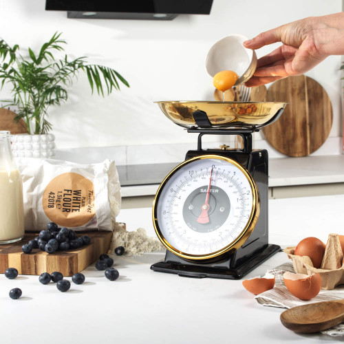 Salter mechanical kitchen scale in gold shown on product packaging
